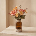 Glass vase with a bouquet of dried flowers